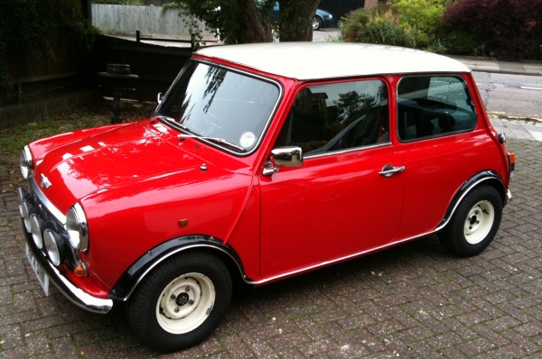 Classic Mini Cooper red with white wheels and roof