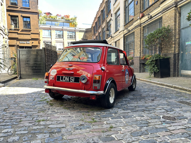 classic red white mini cooper jules small car big city hire london. off side quater