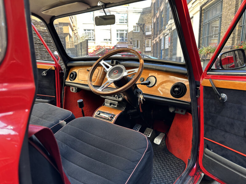 classic red white mini cooper jules small car big city hire london.jpeg driver