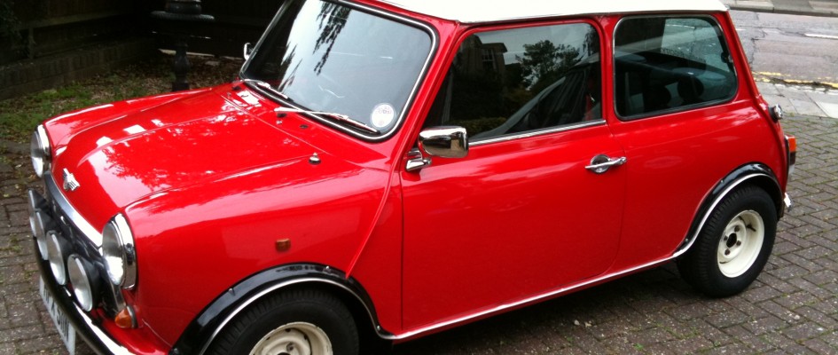 Classic Mini Cooper red with white wheels and roof